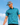 Model wearing the Extinct Polo paired with the Triceraputts Hat on the golf course. Blue sky is featured in the background behind the model