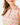 Close up on the collar of the Fairway Fiesta Sleeveless Polo on a model in front of a light gray background.