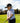 Model wearing the Fast Lane Polo on the golf course with greenery in the background.