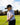 Model wearing the Fast Lane Polo on the golf course with greenery in the background.