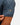 Waggle Logo on the left sleeve of the Fish Finder Polo on a male model in front of a white background