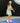 Model wearing the Flora Podium Dress while playing pickleball.
