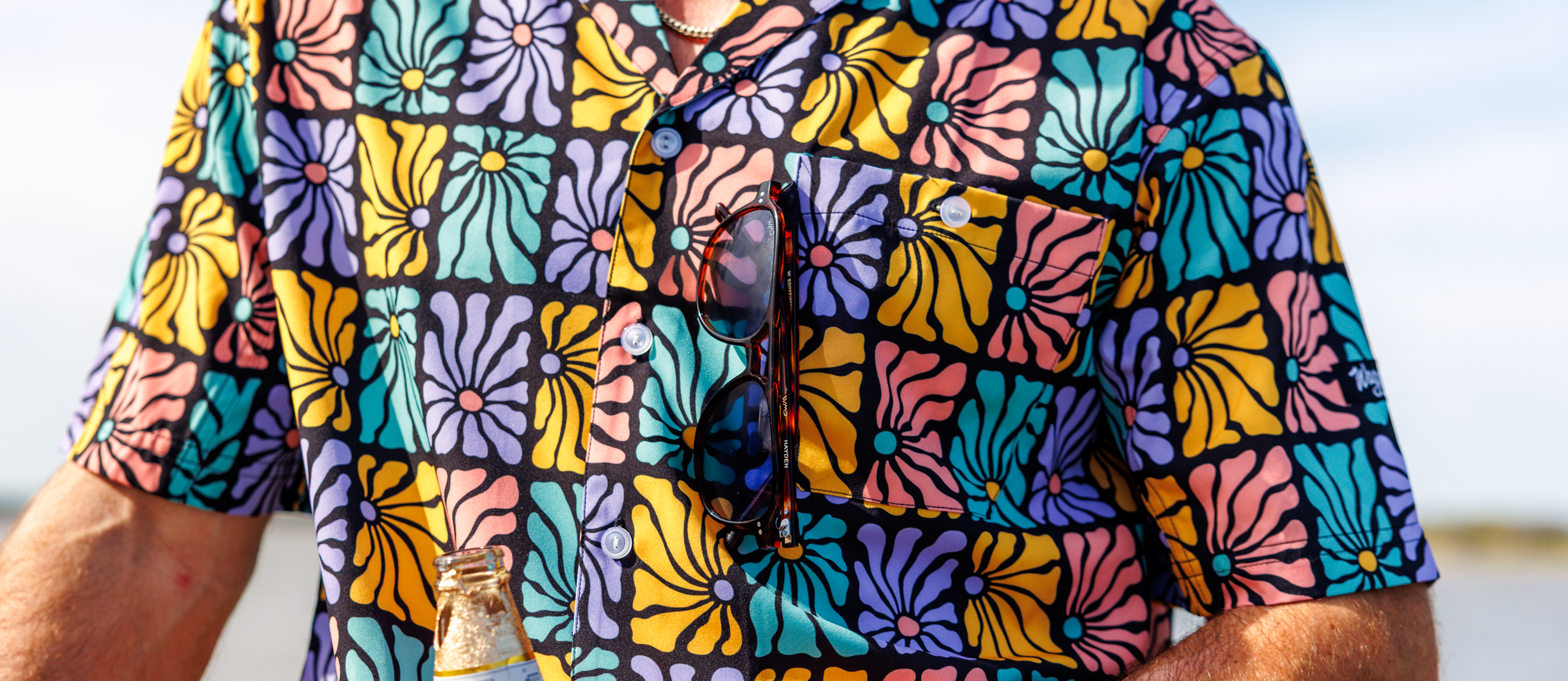 Close up image of Flower Power Camp Shirt showcasing the sunglasses holder feature.