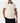 Front of the Flush Habitat Polo on a model in front of a light gray background.