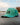 Flying V Repel Hat sitting on a dock with water and trees in the background.