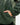 Close up on the left side pocket on the fraser sherpa pullover, on a model in front of a light gray background