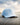 Freshwater Repel Hat sitting on a dock with water and sky in the background.