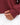Close up on the thumb hole on the sleeve cuffs of the Garnet Plume Funnel Neck Sweatshirt on a model in front of a white background
