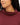 Close up on the funnel neck rolled up on the Garnet Plume Funnel Neck Sweatshirt on a model in front of a white background