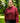 Female model wearing the Garnet Plume Funnel Neck Sweatshirt outside with greenery in the background