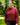 Female model wearing the Garnet Plume Funnel Neck Sweatshirt outside with greenery in the background