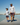 Father and son walking down a dock dressed in hoodies and swim shorts.