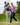 Two golfers celebrating on a golf course with trees in the background wearing two of the new Waggle polos.