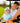 Model wearing the Snack Shack Sleeveless Polo in a golf cart with her son.