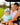 Model wearing the Snack Shack Sleeveless Polo in a golf cart with her son.