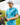 A male model wearing the Hawaiian Punchout Polo on the golf course with greenery & sky in the background