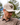 A male model wearing the Highlander Hat outside with greenery & blue sky in the background