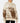 Front of the Highlander Wildknit Sweater on a Female Model in front of a light gray background.