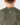 Close up on the Waggle W logo on the back of the Hunter Green Hexcore T-Shirt on a model in front of a light gray background.