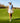 Model wearing the In Bloom Sleeveless Polo on the golf course walking down a fairway.
