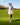 Model wearing the In Bloom Sleeveless Polo on the golf course walking down a fairway.