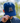 A male model wearing the Kodiak Hat outside with greenery in the background