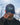 Model wearing the Loon Lake Topographic Hat doing a hat tilt with blue sky in the background