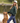 Female model wearing Wildknit Crewneck Sweater while standing by a pond with her dog.