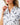 Collar on the Mama Bear Polo on a model in front of a light gray background.