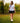 Model wearing the Mama Bear Polo walking a tee box on the golf course with trees in the background.