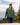 Model wearing the Moss Waffle Knit Hoodie outside walking up a set of stairs with a lake and trees in the background.