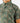 Close up on the left chest pocket on the Muskied Outpost Button-Down Shirt on a model in front of a light gray background.