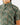 Close up on the left chest pocket on the Muskied Outpost Button-Down Shirt on a model in front of a light gray background.
