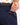 Close up on the Magnetic pocket on the back right side of the Navy Ace Pants on a model in front of a white background