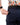 Close up on the Zippered pocket on the back left side of the Navy Ace Pants on a model in front of a white background