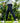 Model wearing the Ace Pants outside with greenery in the background