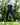 Model wearing the Ace Pants outside with greenery in the background