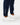 Close up on the ankle cuffs on the Navy Core Sweatpants on a model in front of a light gray background.