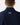 Close up on the Waggle Logo on the back of Navy Endeavor Jacket on a model in front of a light gray background.
