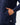 Close up on one of the front hand pockets on the Navy Endeavor Jacket on a model in front of a light gray background.