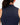 Close up on the back Waggle W logo on the Navy Matchplay Mock Neck on a model in front of a light gray background.