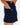 Close up on the tee loop featured on the left side of the Pacesetter Skort on a model in front of a light gray background.