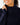 Close up on the Funnel Neck on the Navy Plume Funnel Neck on a model in front of a light gray background.