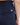 Close up on the pocket on the back right side of the Rhythm Pants on a model in front of a white background