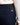 Close up on the pocket on the back right side of the Rhythm Pants on a model in front of a white background