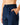 Close up on the elastic waistband on the Navy Greenside Cargo Joggers on a model in front of a light gray background.