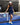 Model wearing the Navy Matchplay Mock Neck leaning against the net on a pickleball court.