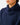 Close up on the snap closure on the Navy Core Hoodie on a model in front of a light gray background.