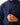 Close up on the front chest pocket on the Navy Endeavor Jacket on a model in front of a light gray background.