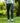 Model wearing the Ace Pants outside with greenery in the background